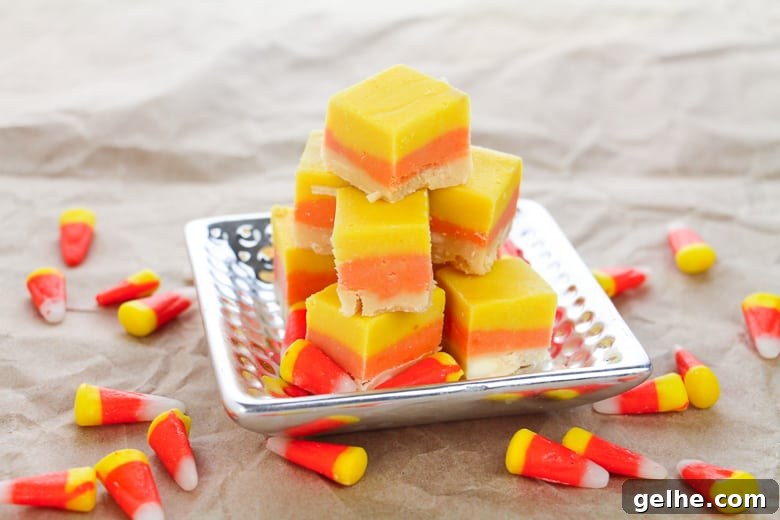 Candy Corn Fudge on silver platter, with candy corn sprinkled around the table.