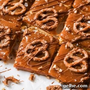 Caramel Cookie Bars on a counter with a drizzle of chocolate.