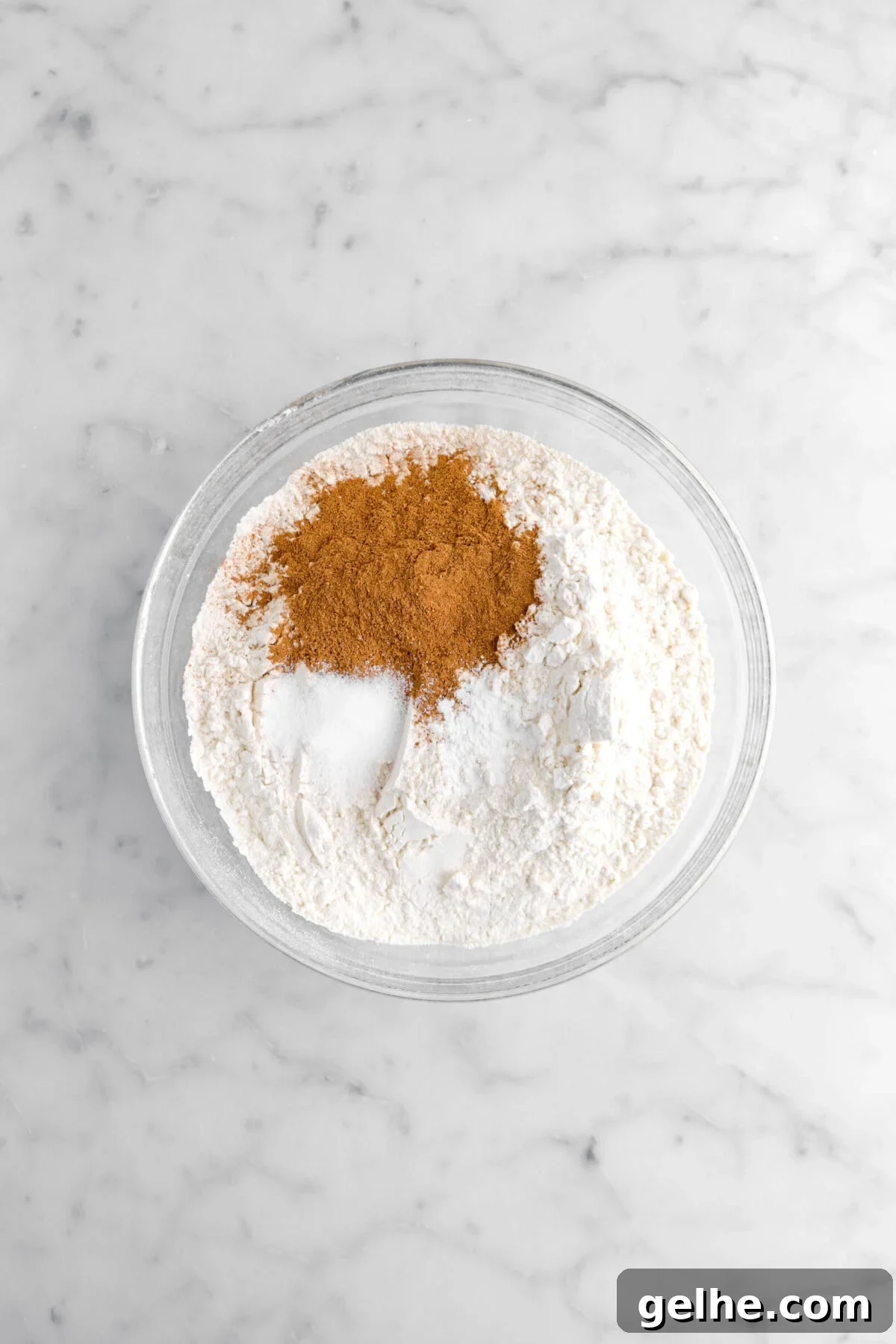 flour, salt, baking soda, and pumpkin pie spice in glass bowl.