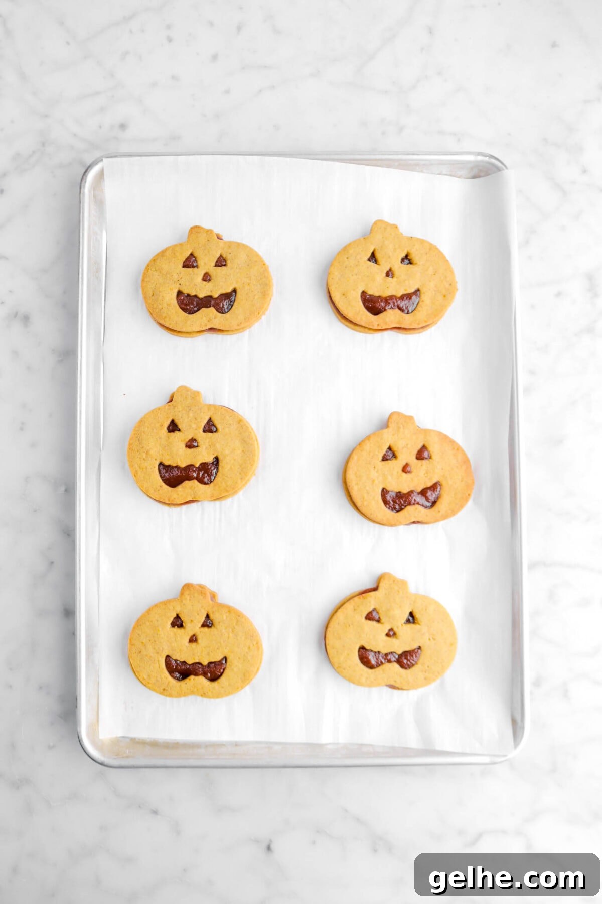 jack o'lantern cookies on sheet pan.