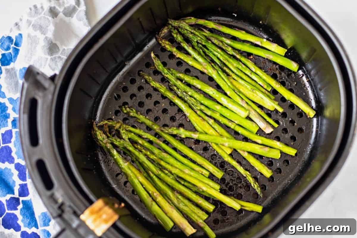 Asparagus in air fryer basket before cooking.