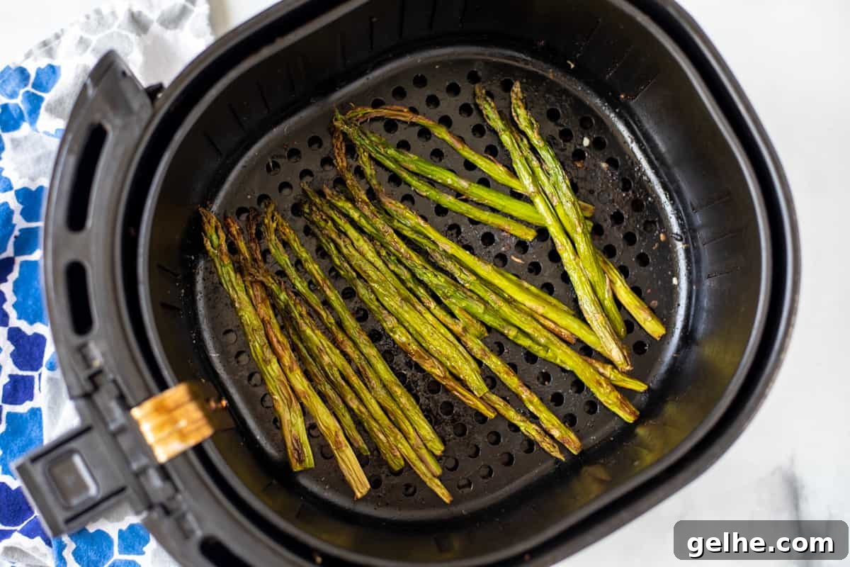 Roasted Asparagus in the air fryer basket.