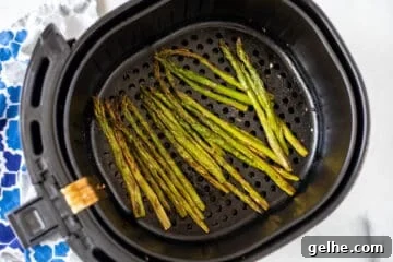 Air Fried Asparagus in the air fryer basket.