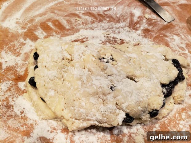 Half of the biscuit dough is pulled up and over the blueberries.