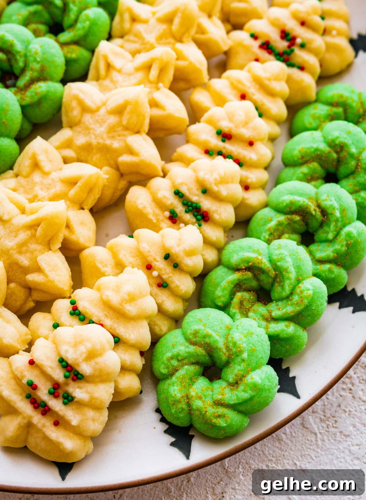 All the decorated spritz cookies on a beautiful festive cookie platter ready to serve.
