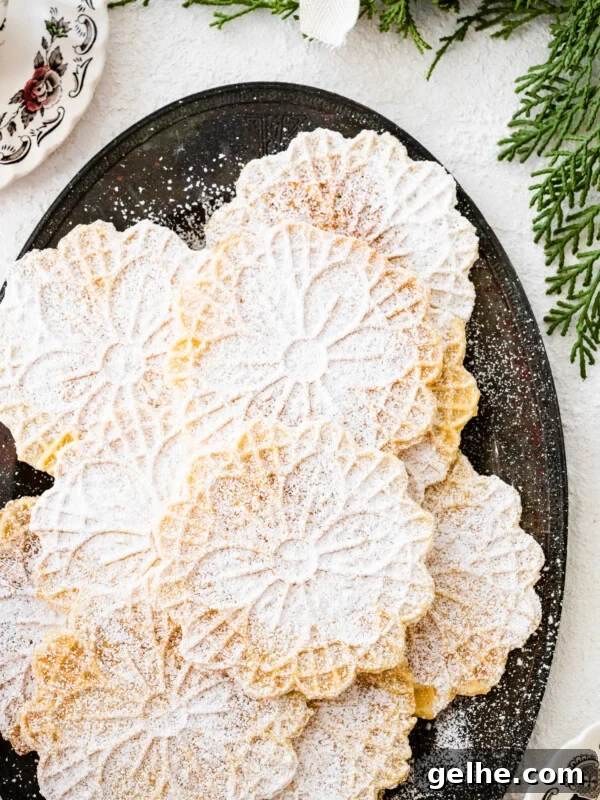Freshly baked pizzelle cookies on a platter.