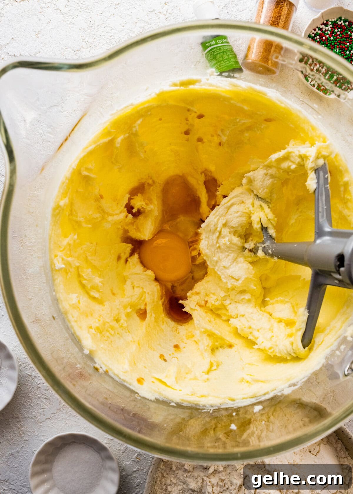 How to make Spritz cookies step-by-step: cream the butter and sugar and add the egg.