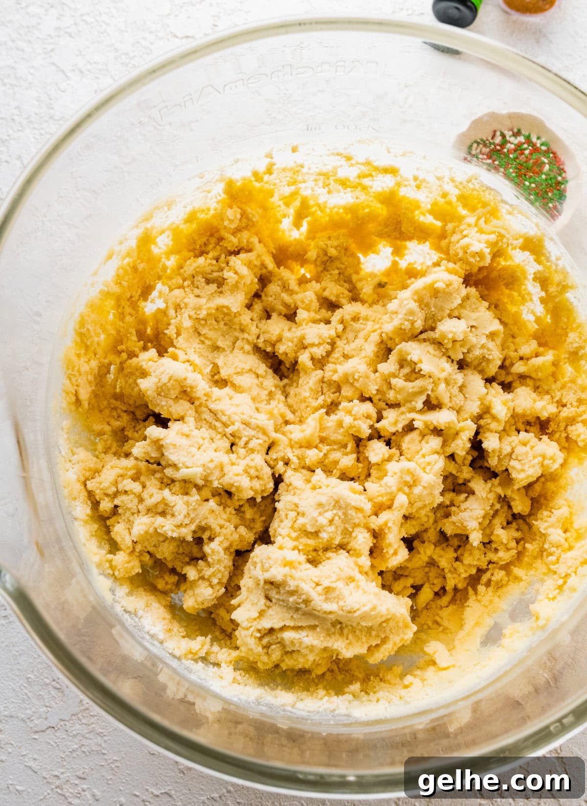 How to make Spritz cookies step-by-step: mix the wet and dry ingredients to form a cookie dough.