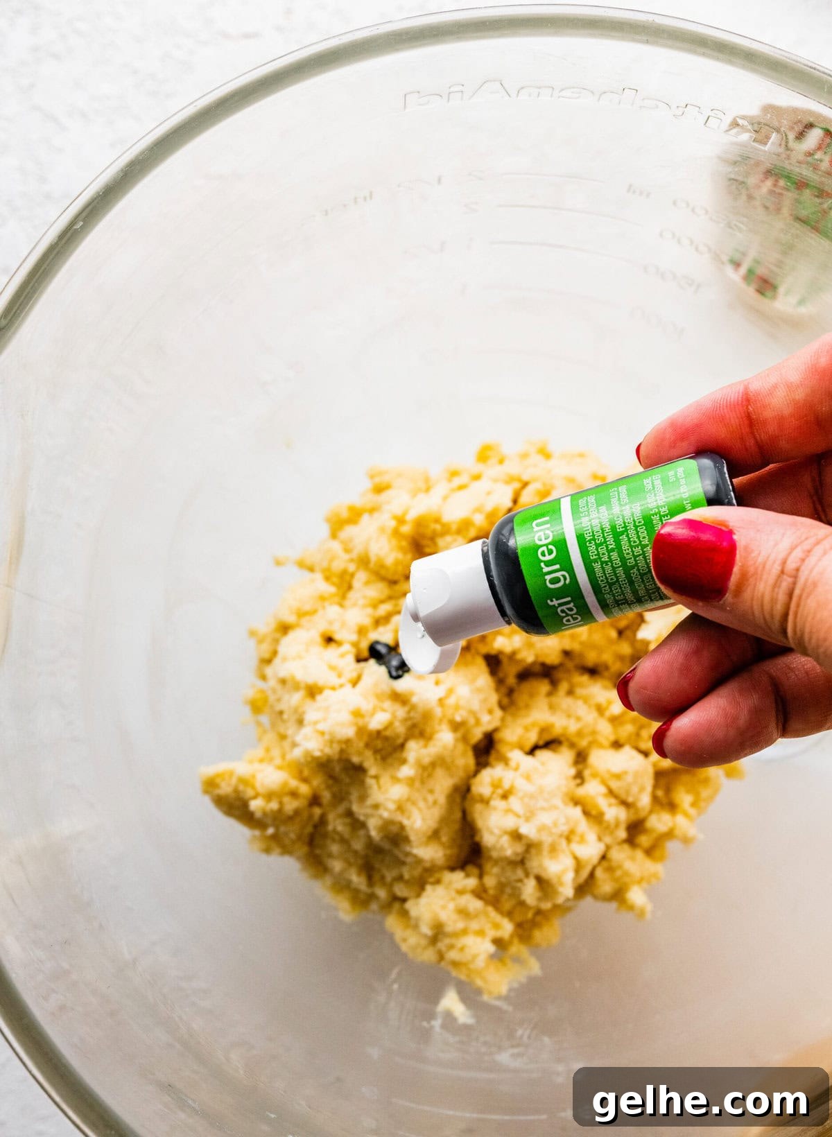 How to make Spritz cookies step-by-step: color half the cookie dough with food gel- if desired.