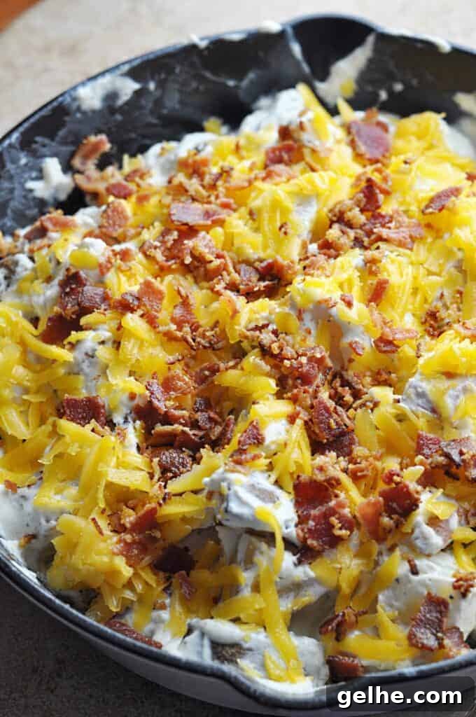 Cheesy Ranch Bacon Roasted Potatoes for Weeknight Dinners 5 Bacon Ranch potatoes covered in cheese and bacon ready for the oven