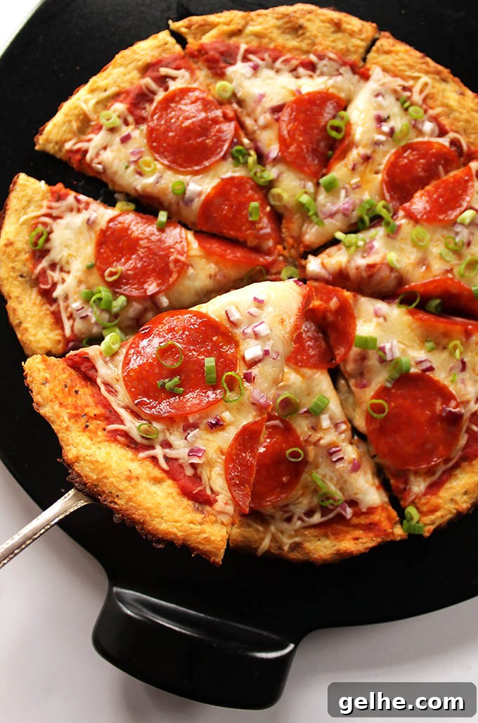Easy Cauliflower Pizza Crust - A HEALTHY, delicious, pizza crust that won't fall apart. You can top the pizza with anything you prefer. Gluten Free. |robustrecipes.com