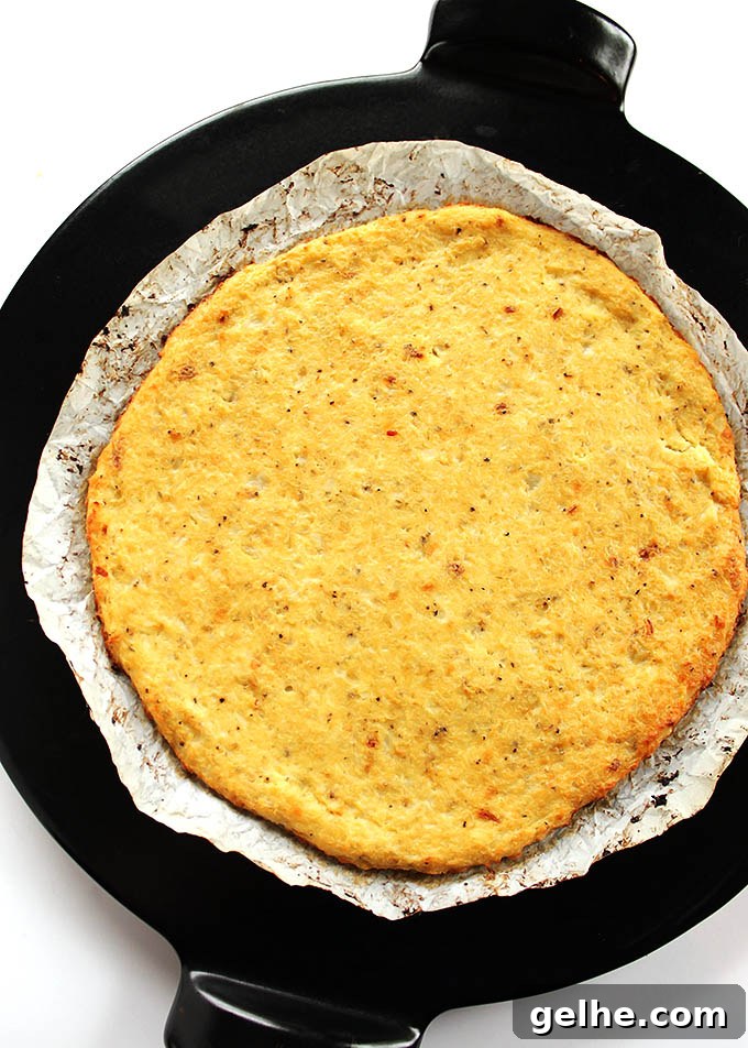Easy Cauliflower Pizza Crust - The trick is to use frozen, thawed cauliflower florets! A HEALTHY, delicious, pizza crust that won't fall apart! Gluten Free | robustrecipes.com