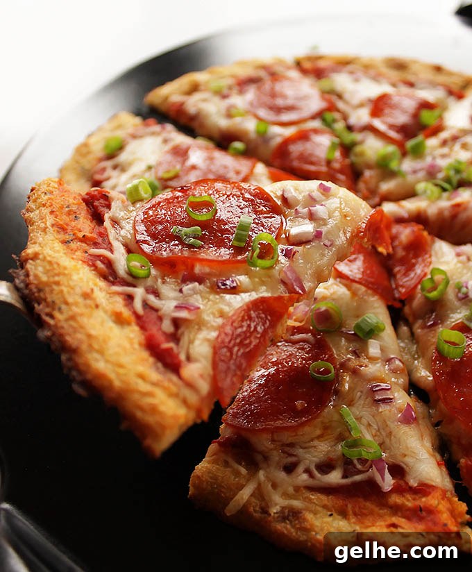 Easy Cauliflower Pizza Crust - The trick is to use frozen, defrosted cauliflower florets - they make everything a lot easier! This crust is delicious, HEALTHY, won't fall apart, and can be topped with anything! Gluten Free. | robustrecipes.com