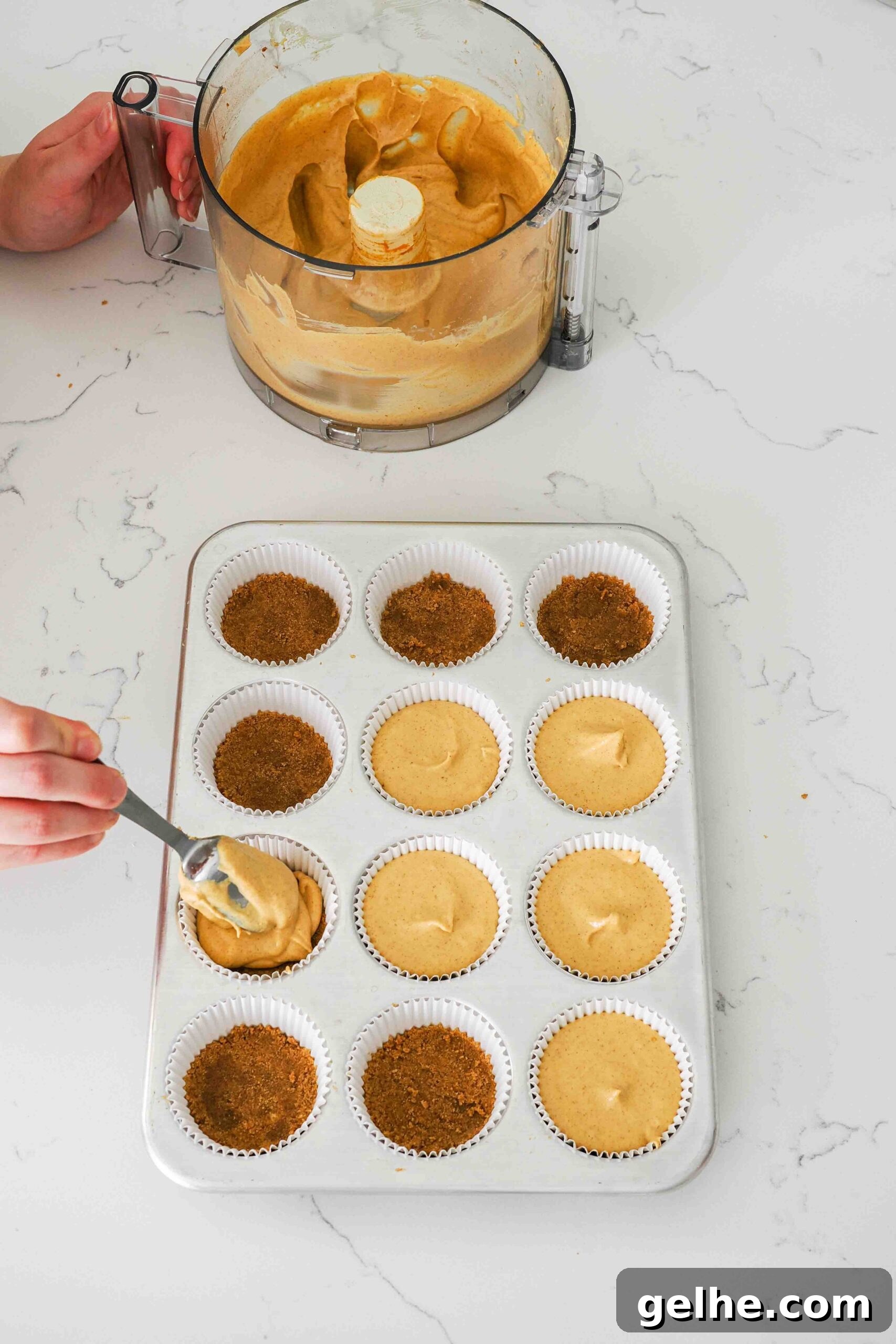 Mini Pumpkin Cheesecake Bites: Creamy Fall Dessert Recipe 11 Pumpkin cheesecake is scooped into paper muffin liners.