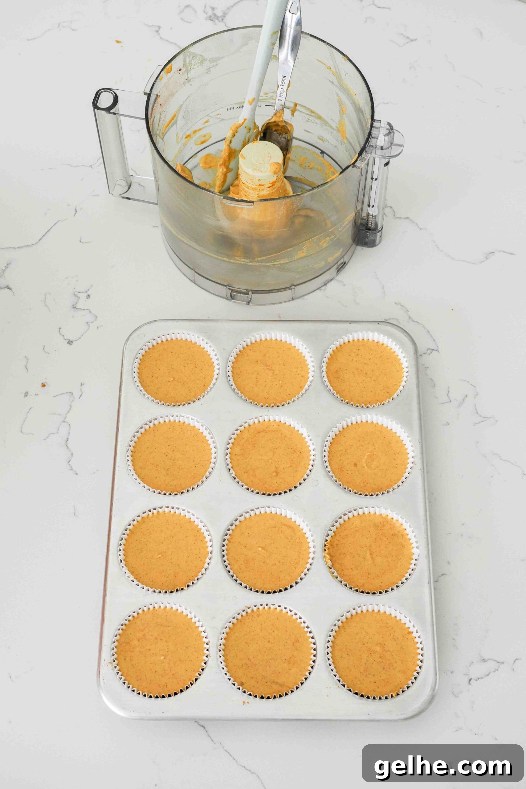 Mini Pumpkin Cheesecake Bites: Creamy Fall Dessert Recipe 12 Unbaked mini pumpkin cheesecakes in a muffin pan.