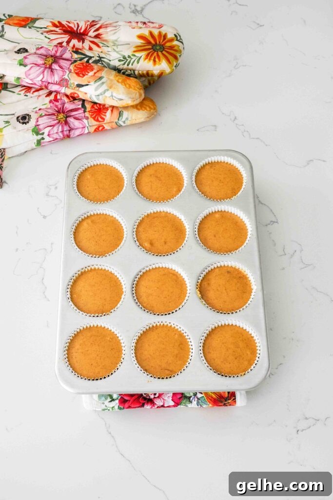 Mini Pumpkin Cheesecake Bites: Creamy Fall Dessert Recipe 13 Baked mini pumpkin cheesecakes in a muffin pan.
