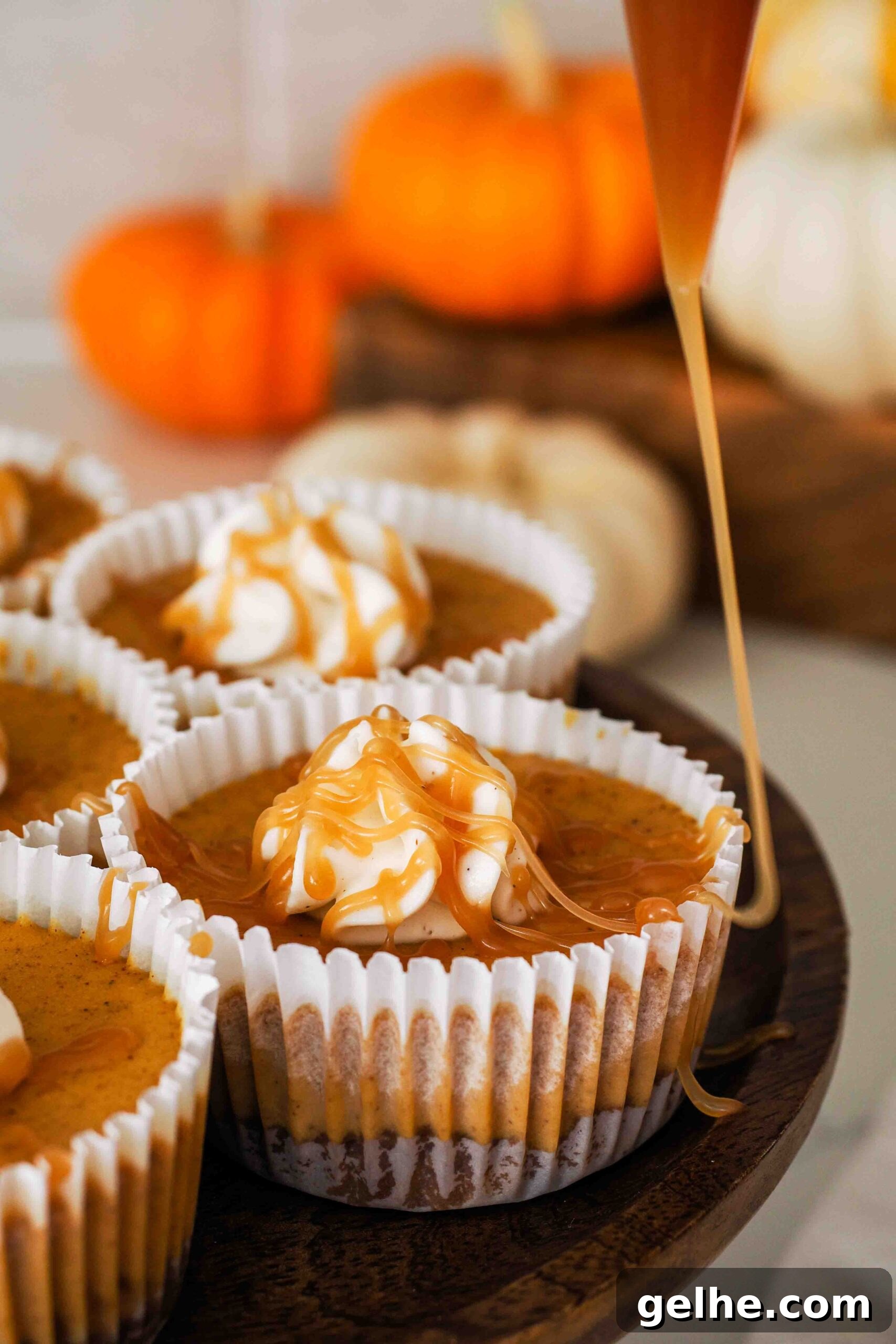 Mini Pumpkin Cheesecake Bites: Creamy Fall Dessert Recipe 15 Caramel is drizzled over a mini pumpkin cheesecake.