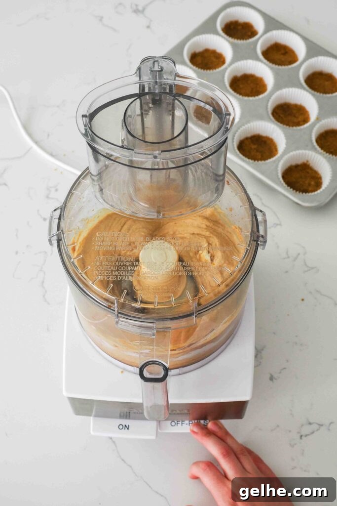 Mini Pumpkin Cheesecake Bites: Creamy Fall Dessert Recipe 8 Pumpkin cheesecake being processed in a food processor.