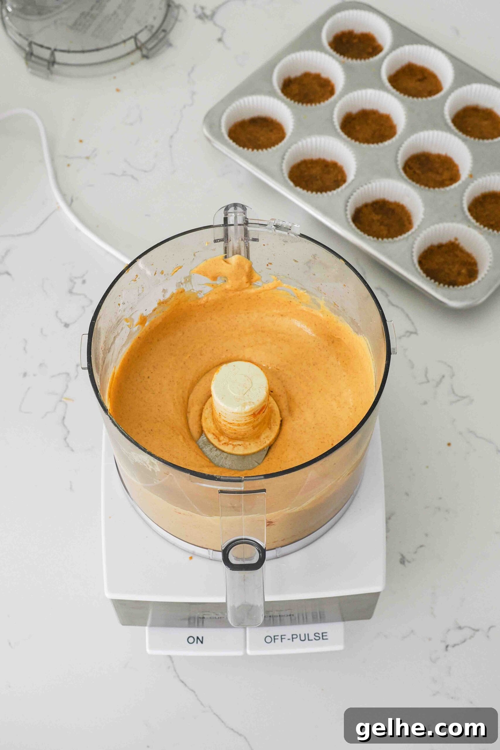 Mini Pumpkin Cheesecake Bites: Creamy Fall Dessert Recipe 10 Smooth and creamy pumpkin cheesecake filling in a food processor.