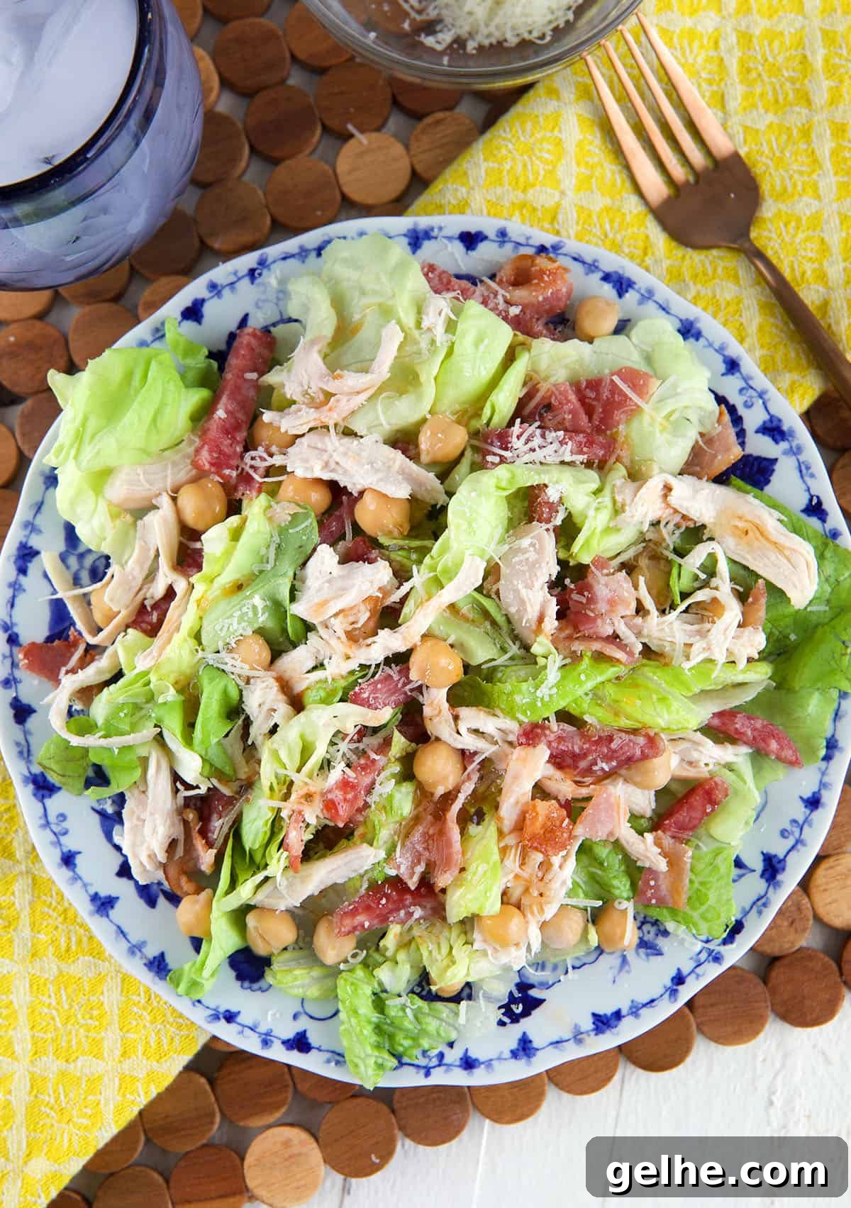 A round plate is topped with salad. 