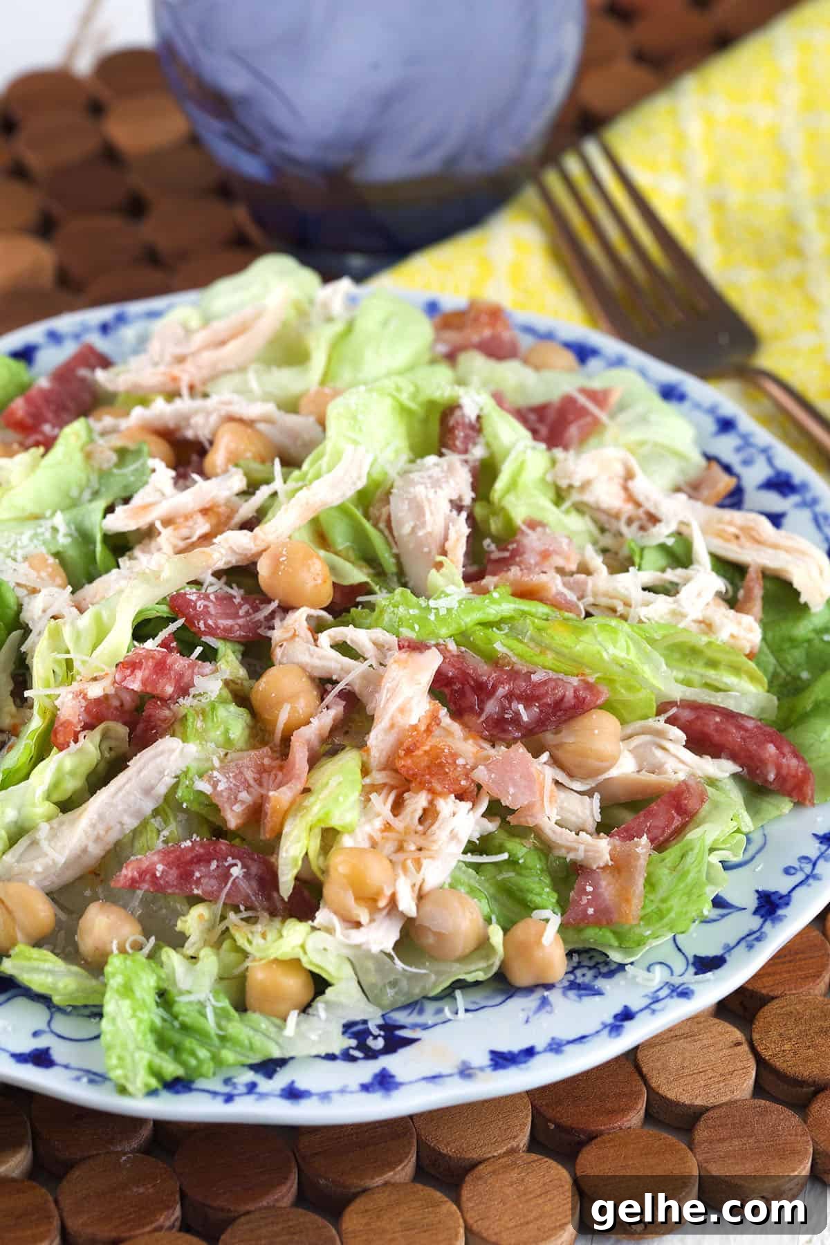 A salad is fully tossed and presented on a plate. 
