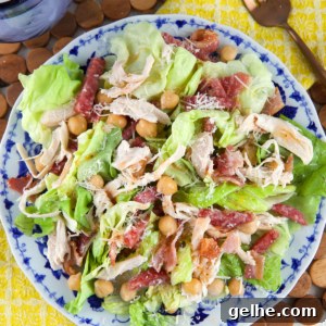 A round plate is topped with salad.