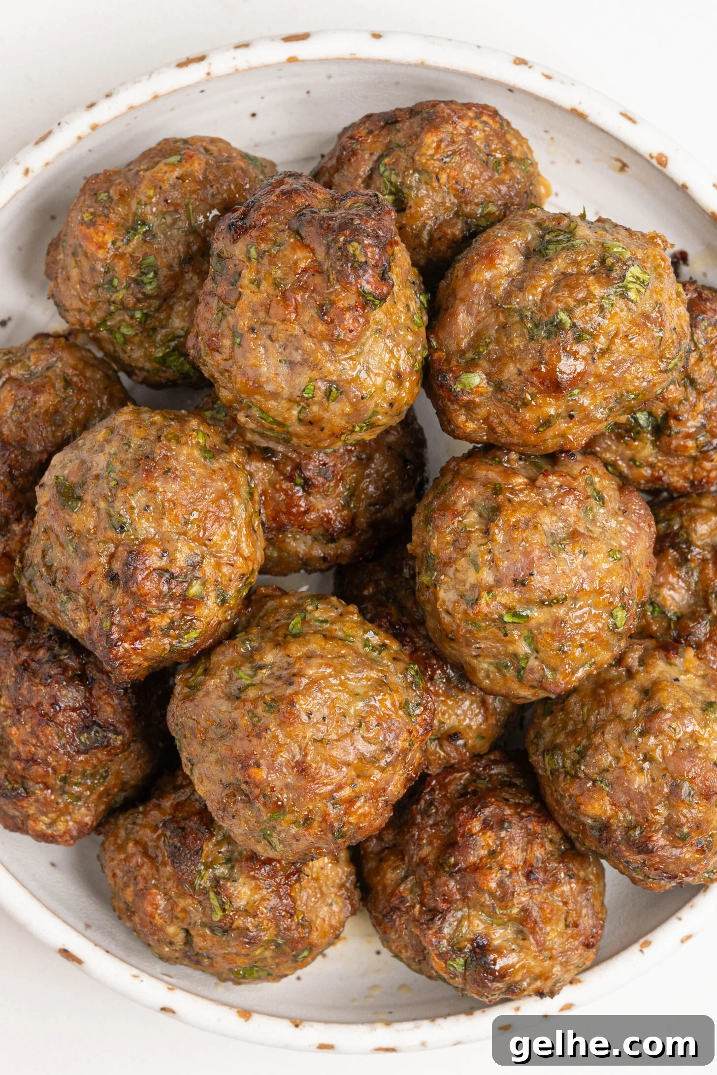 A bowl of baked lamb meatballs.