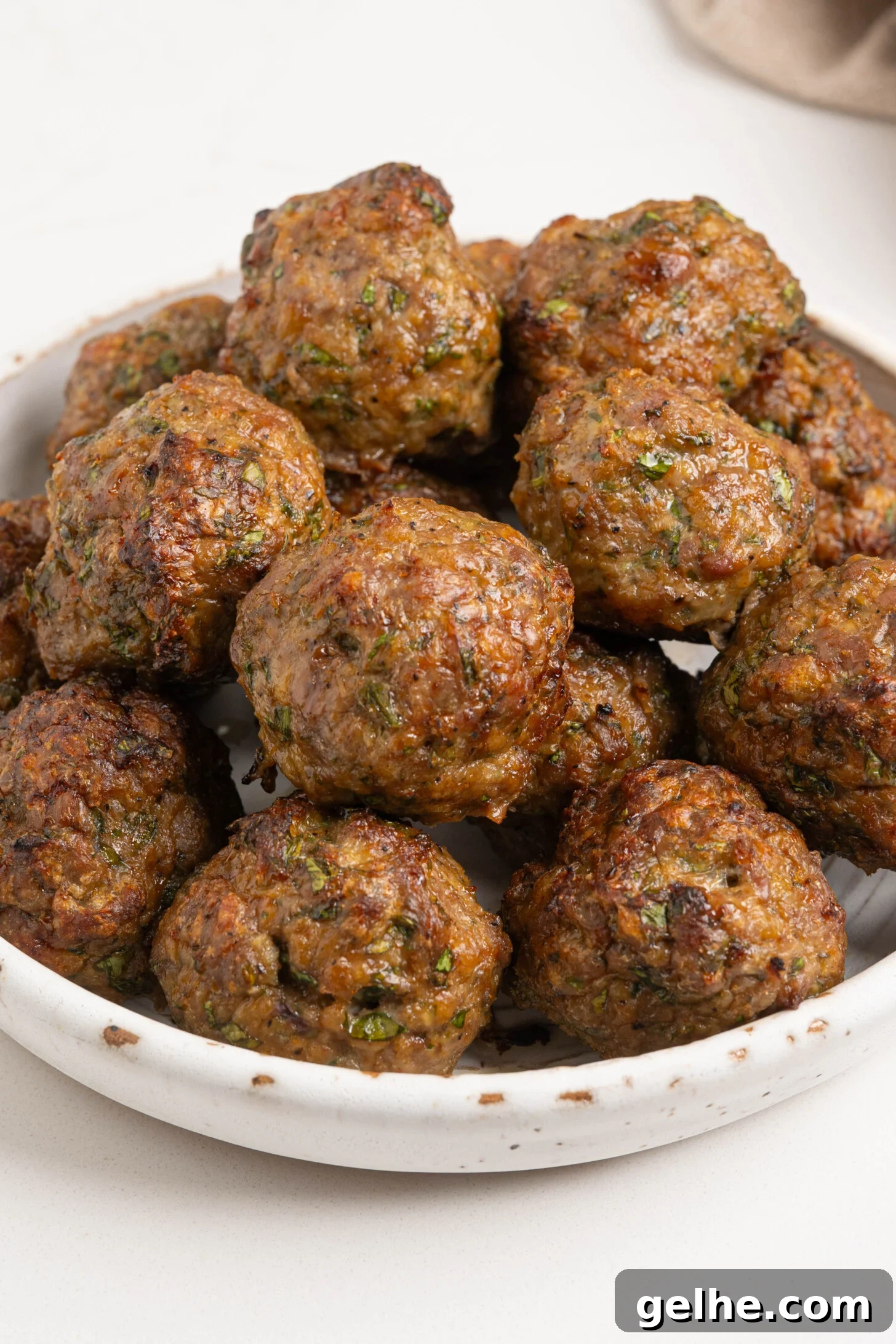 A bowl of baked lamb meatballs.