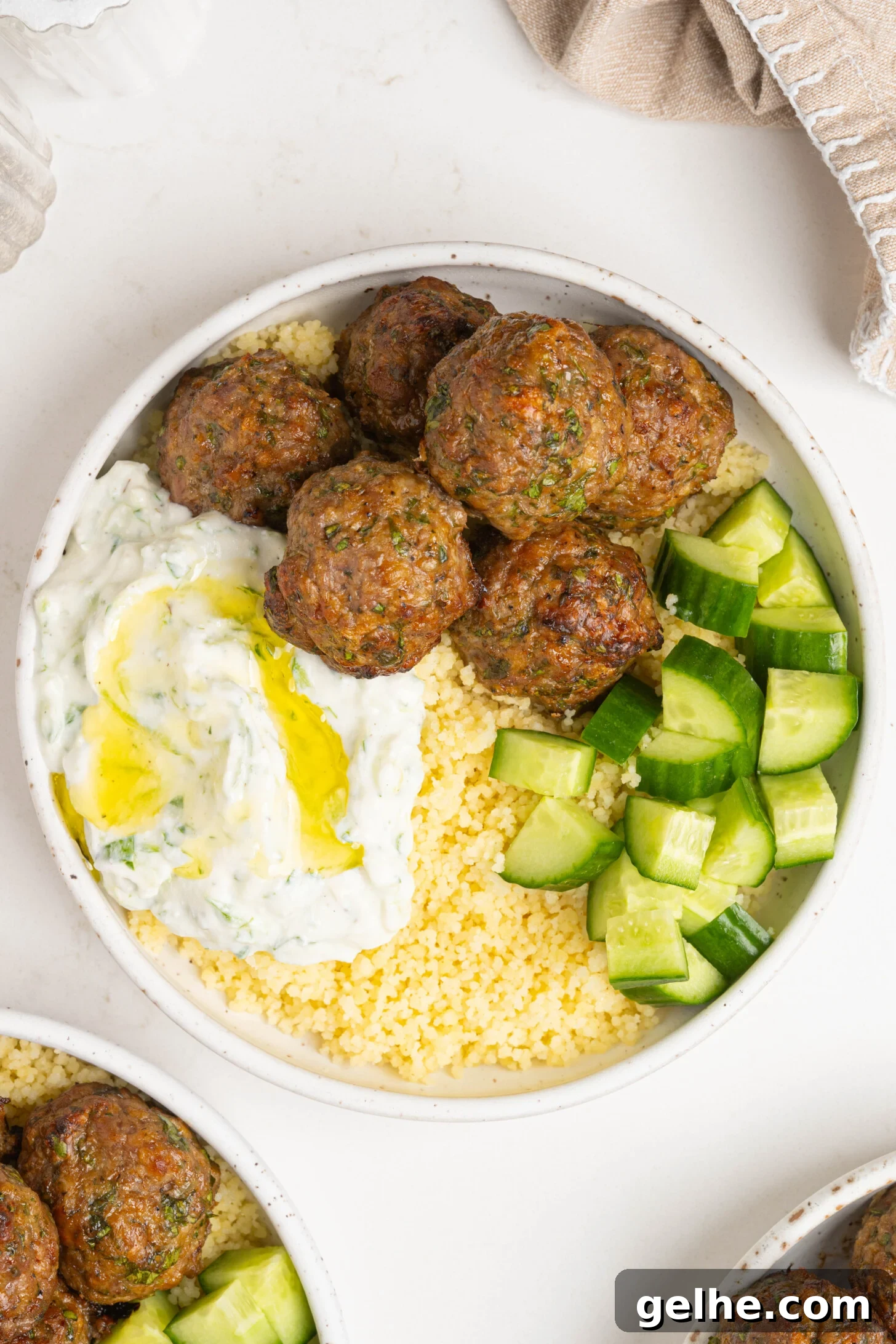 A bowl of couscous, lamb meatballs, and more.