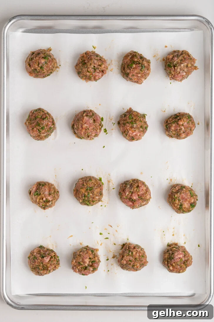 Lamb meatballs on a baking sheet.