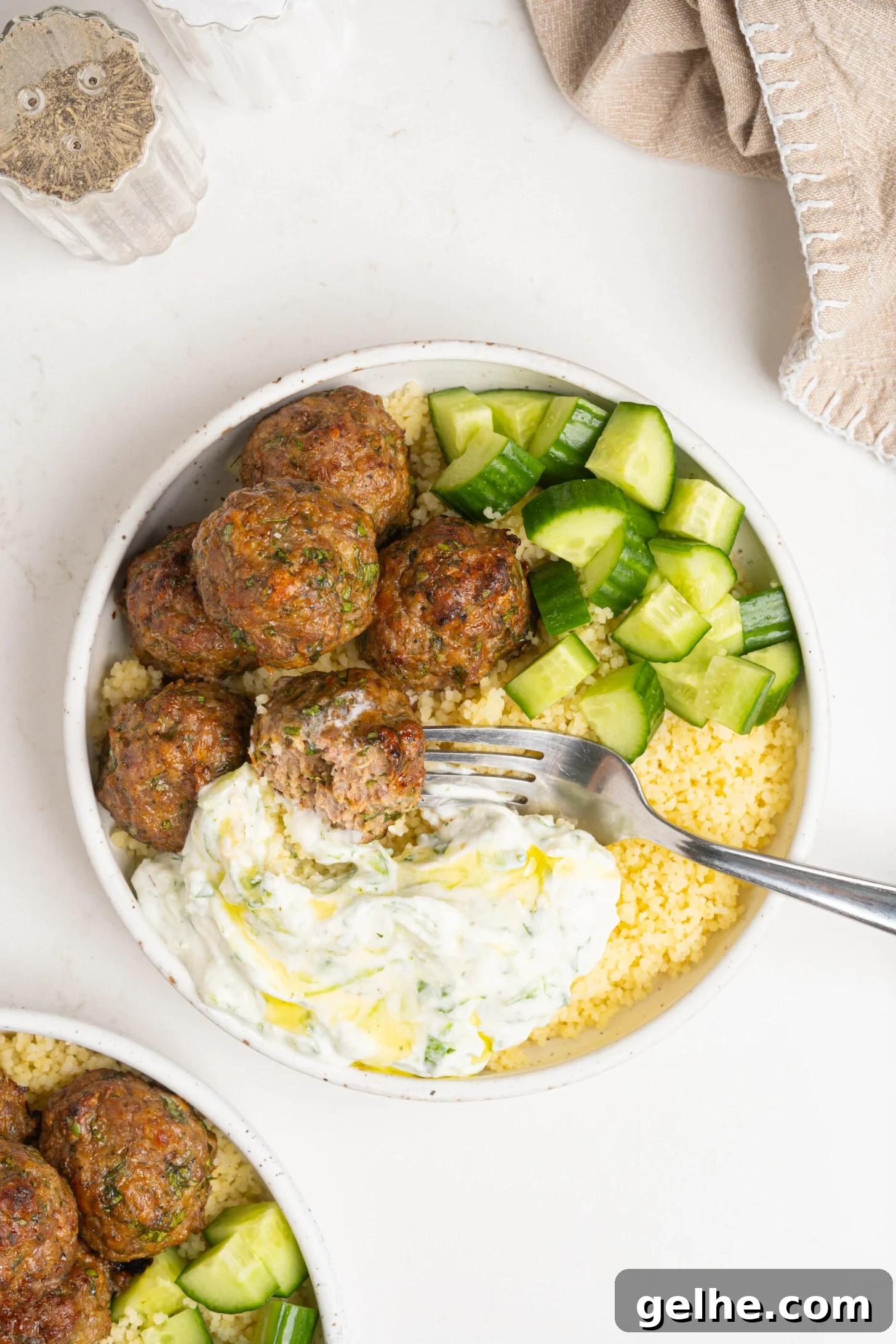 A bowl of couscous, lamb meatballs, and more.