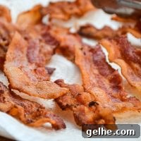 A plate full of draining crispy bacon