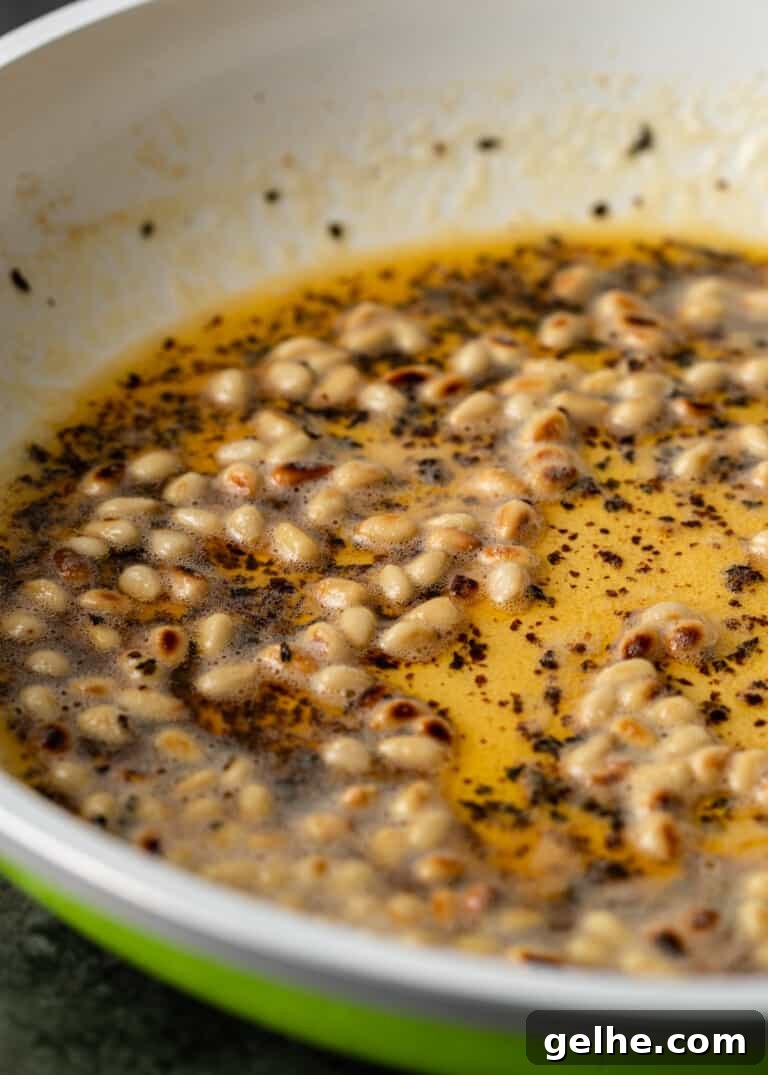 closeup: pine nuts in bowl with butter