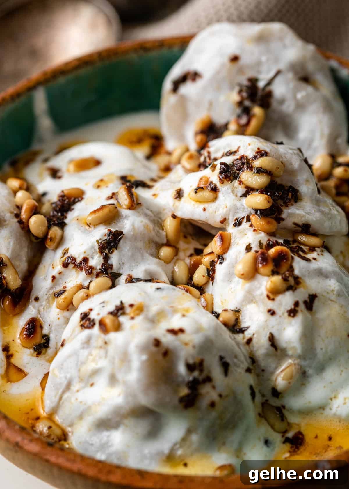 closeup: shish barak recipe with pine nuts on top