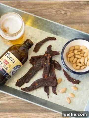 Deer jerky on tray with beer and nuts