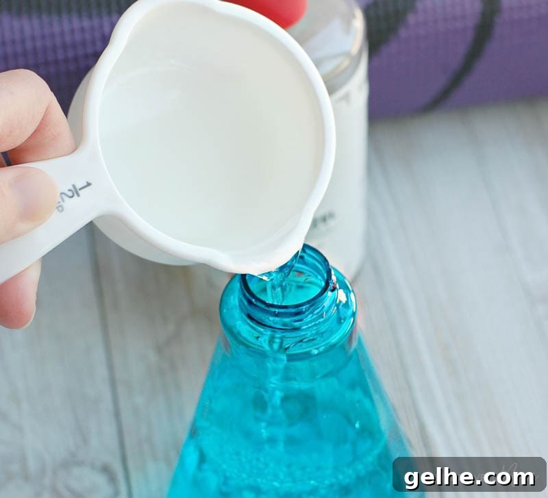 Pouring ingredients into spray bottle