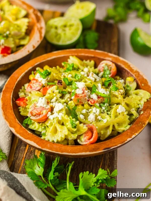 Cilantro lime pasta salad in a wood serving bowl.