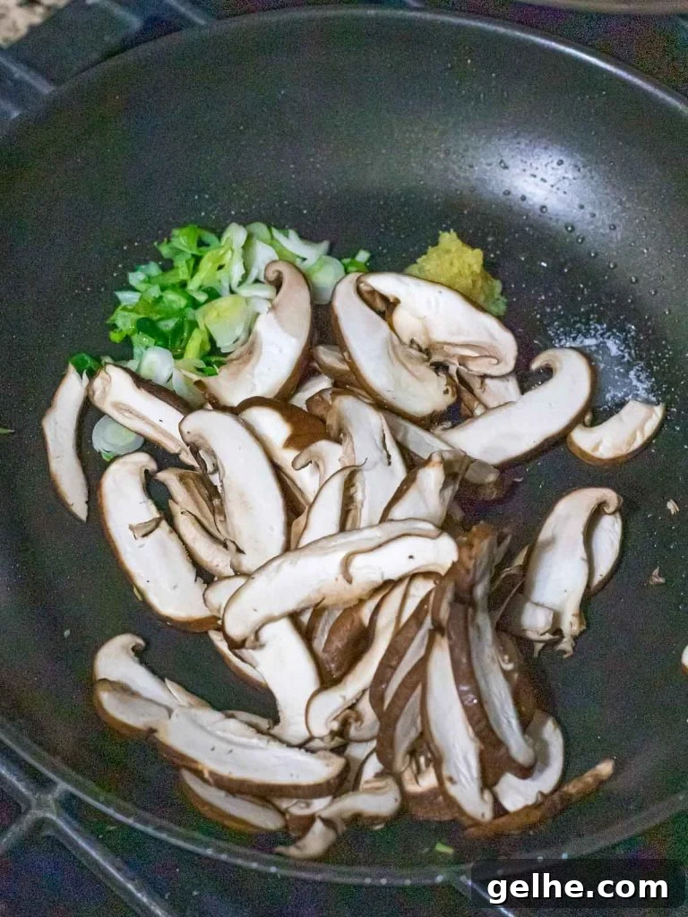 stir fried shiitake mushrooms in a dark pan