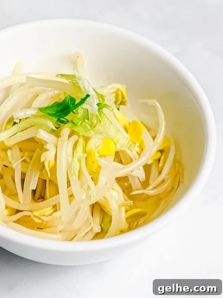 Korean soybean sprout side dish, kongnamul muchim, in a white bowl