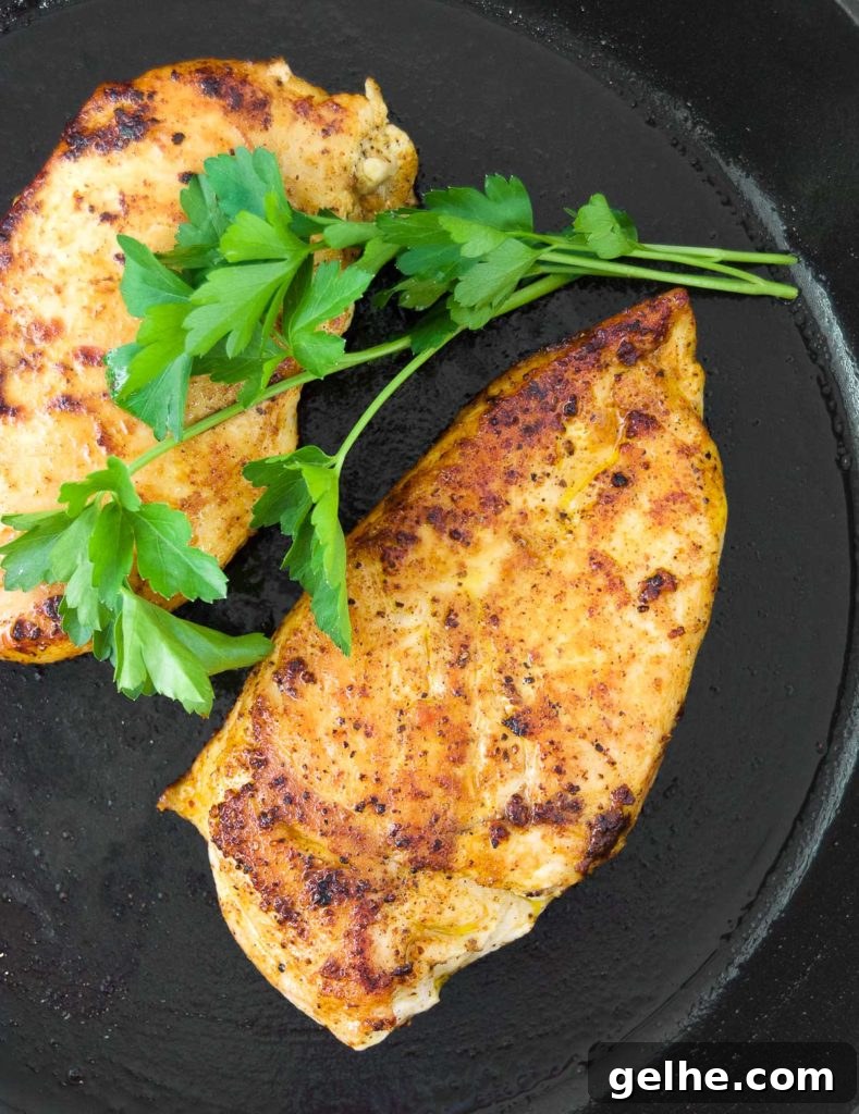 Perfectly Pan-Seared Chicken Breasts: Juicy, Crispy Results Every Time 2 Close up of two chicken breasts in a cast iron skillet