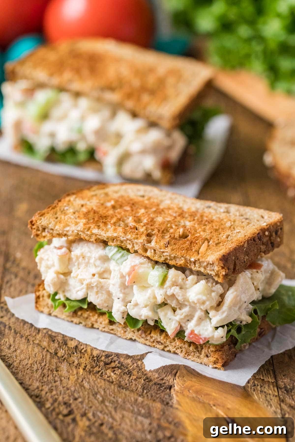 Chicken salad sandwich with lettuce and toasted wheat bread.