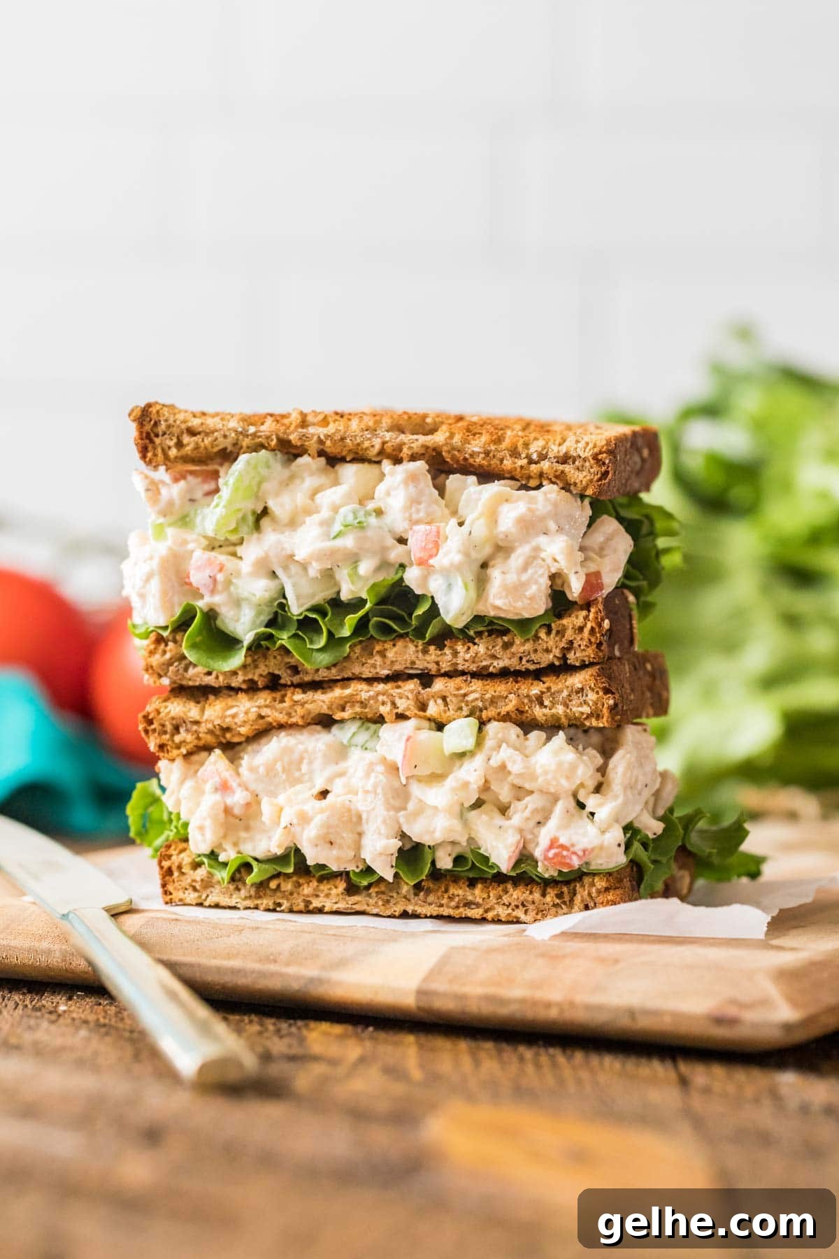 Chicken salad sandwich halves stacked on top of each other.