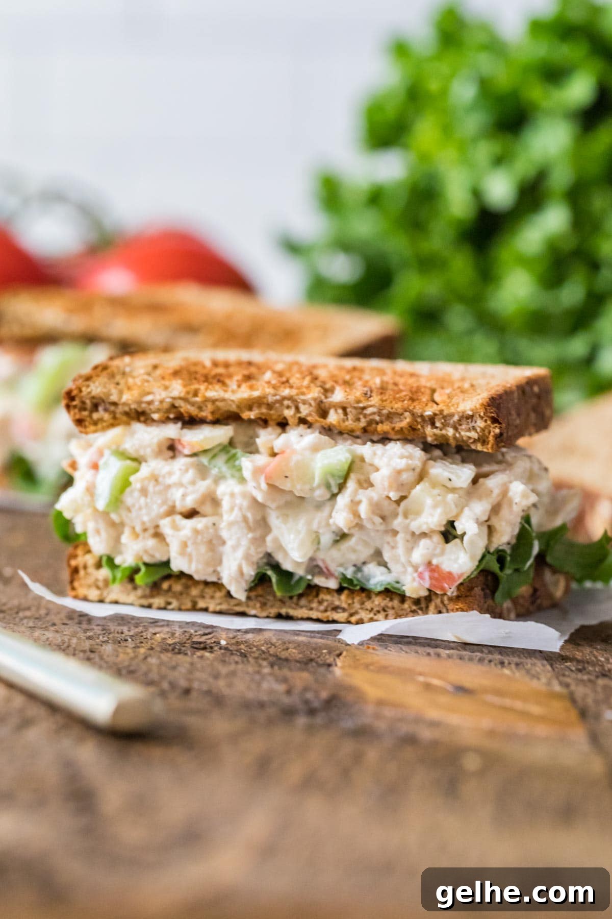 Salad made with chicken, mayo, apples, and more served on toasted wheat bread.