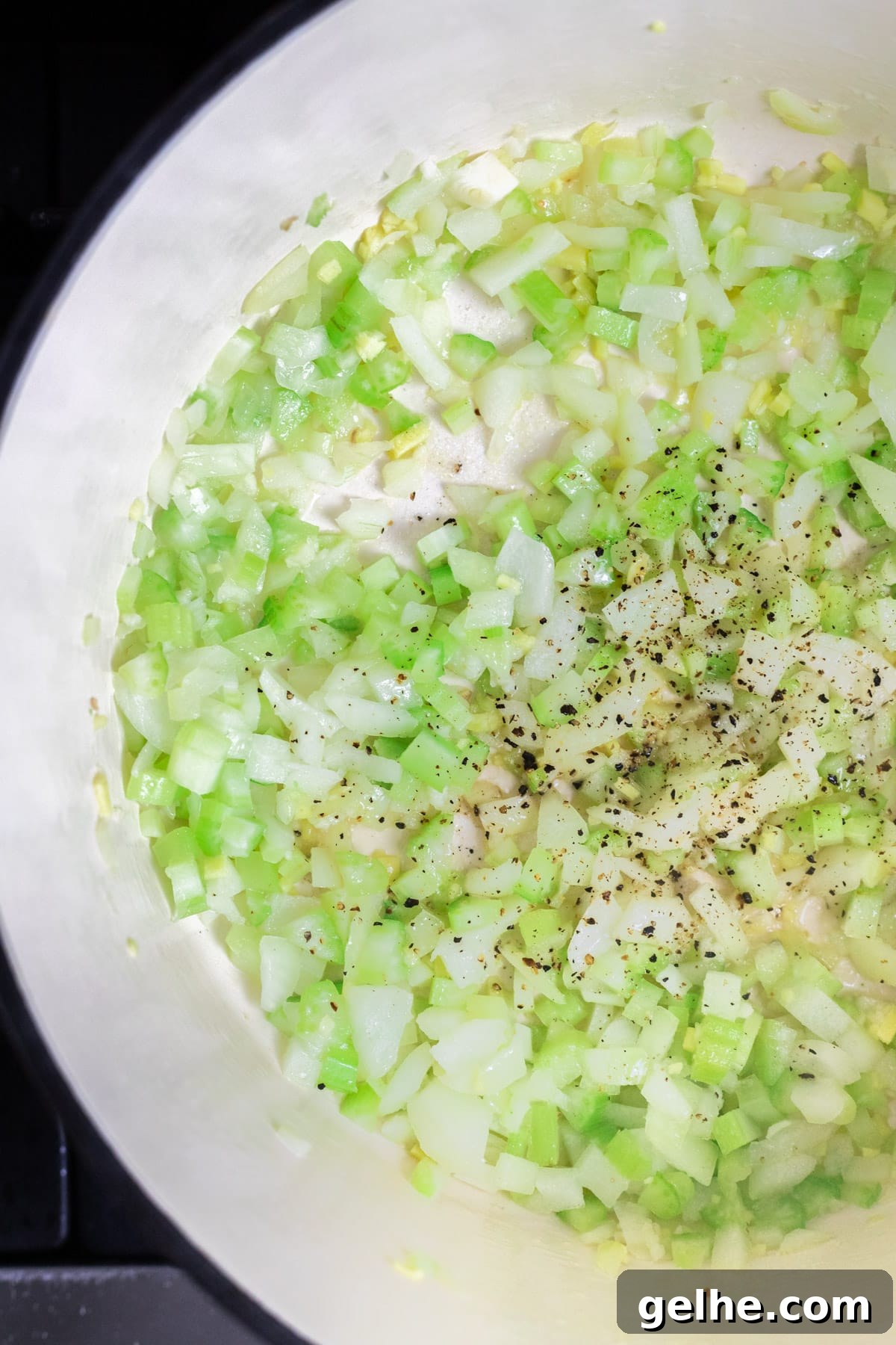 Sautéing celery, onion, garlic and ginger in a Dutch oven.