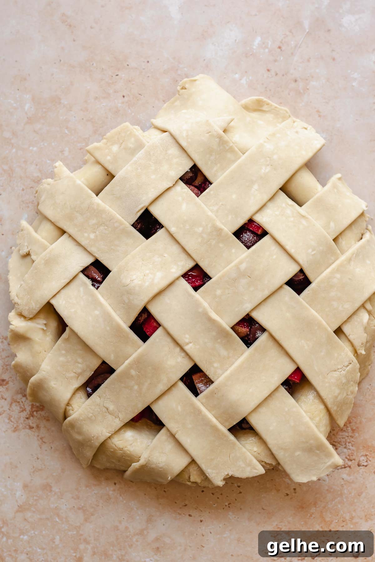 Cherry Rhubarb Pie Recipe: Sweet-Tart Homemade Dessert 11 Lattice strips on top of the pie with overhangs.