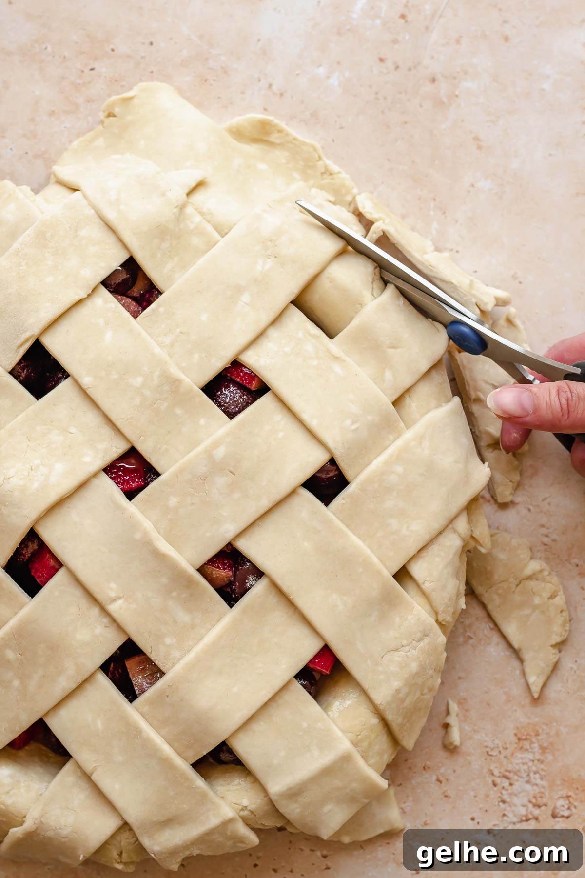 Cherry Rhubarb Pie Recipe: Sweet-Tart Homemade Dessert 12 Scissors cut excess pastry from the sides of a pie dish.
