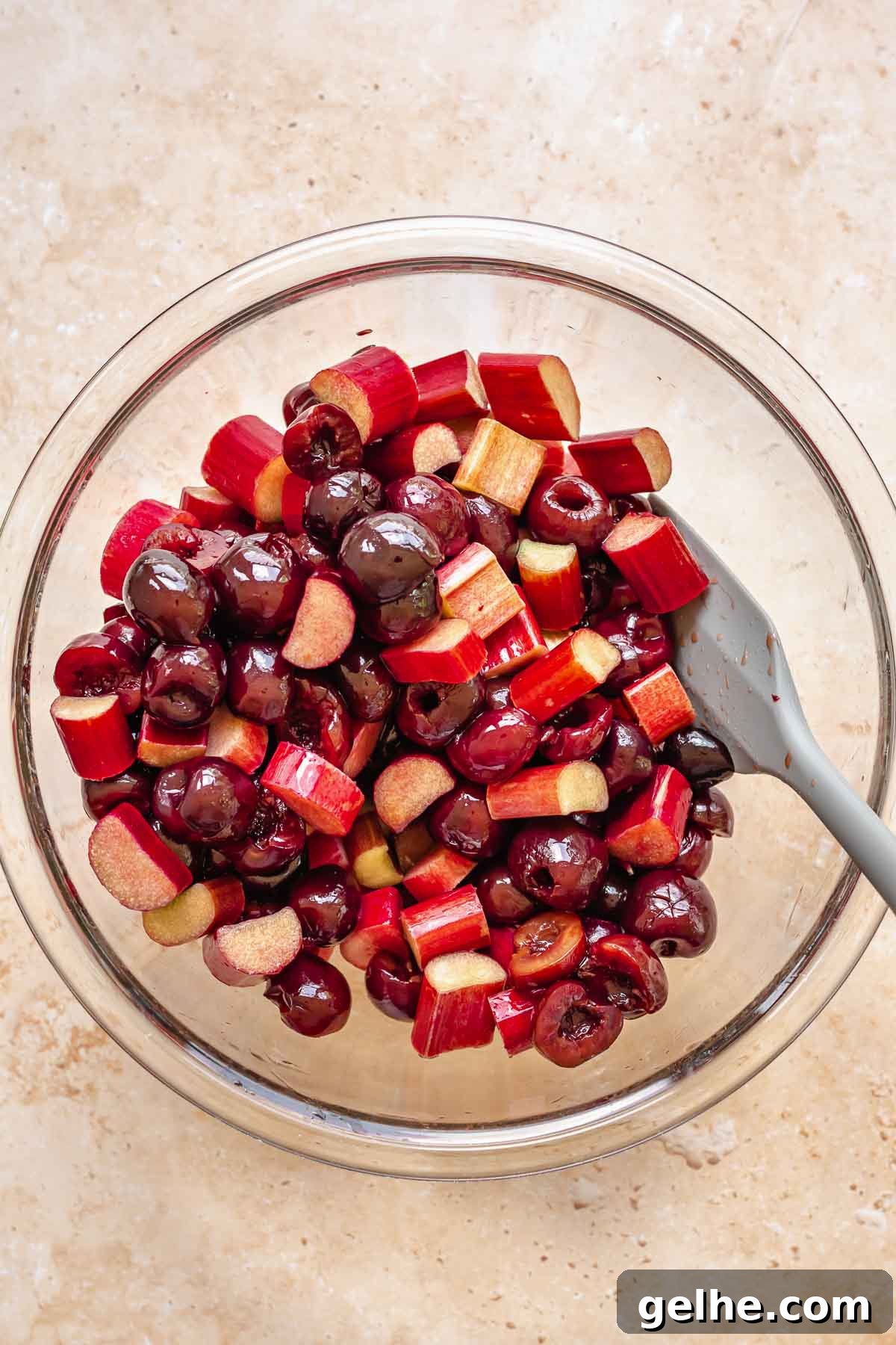 Cherry Rhubarb Pie Recipe: Sweet-Tart Homemade Dessert 4 Cherries and sliced rhubarb in a large bowl, mixed together.