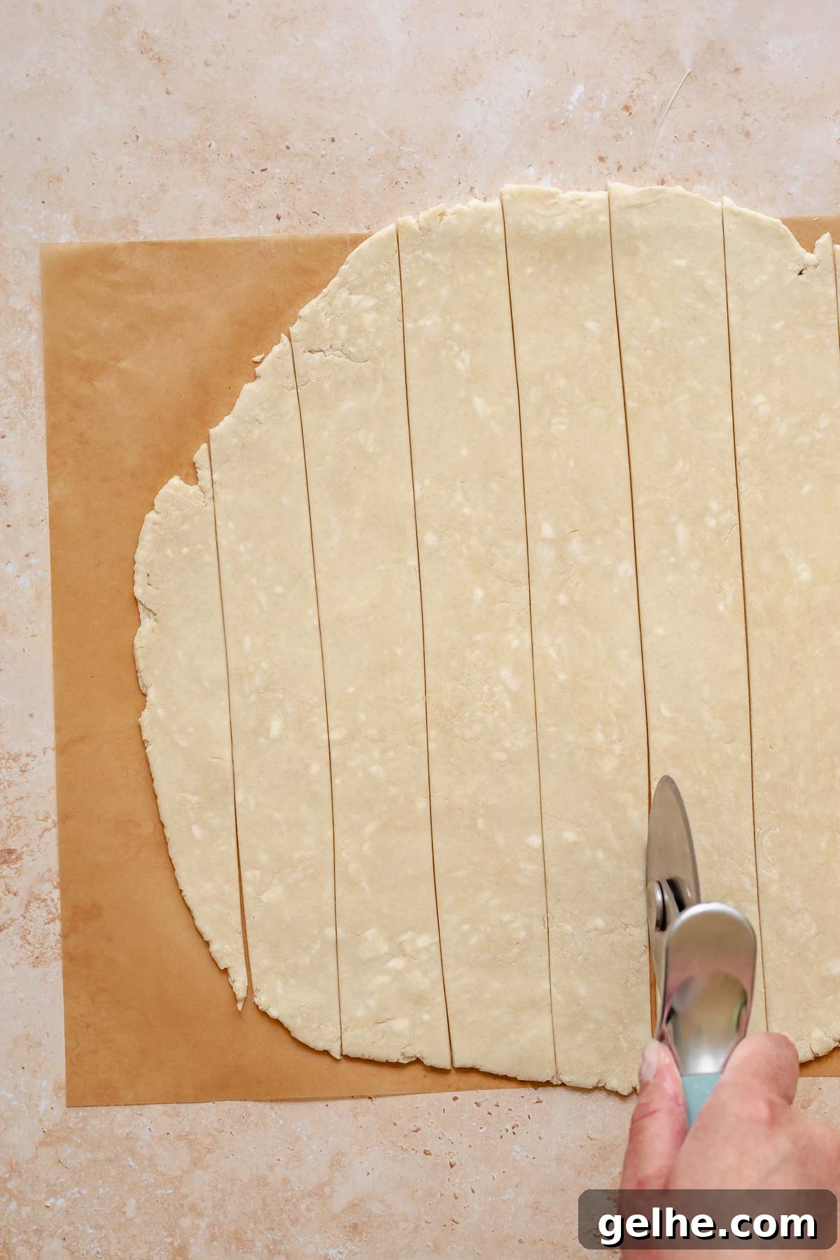 Cherry Rhubarb Pie Recipe: Sweet-Tart Homemade Dessert 9 A pizza roller cuts rolled out pie crust into lattice strips.