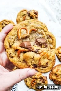 Hand holding up peanut butter pretzel cookie.