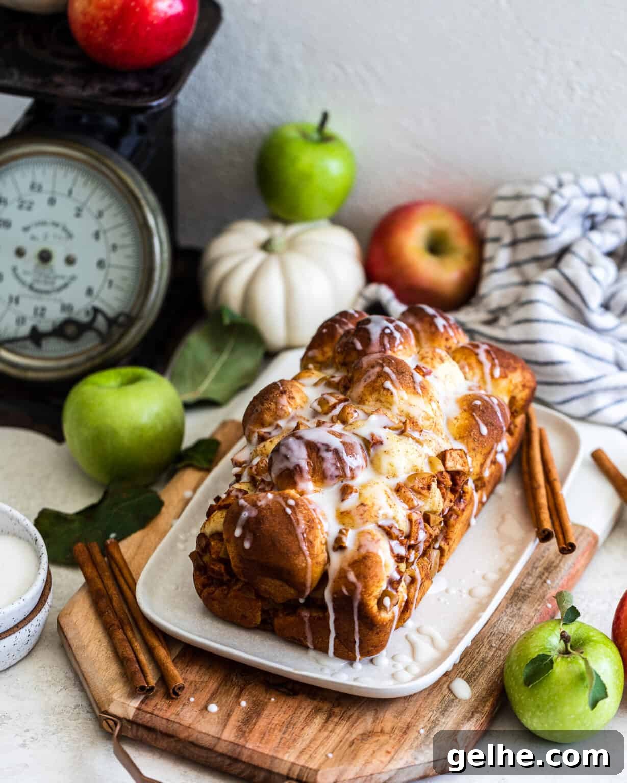 Apple and Pear Bread with apples and a pumpkin behind it